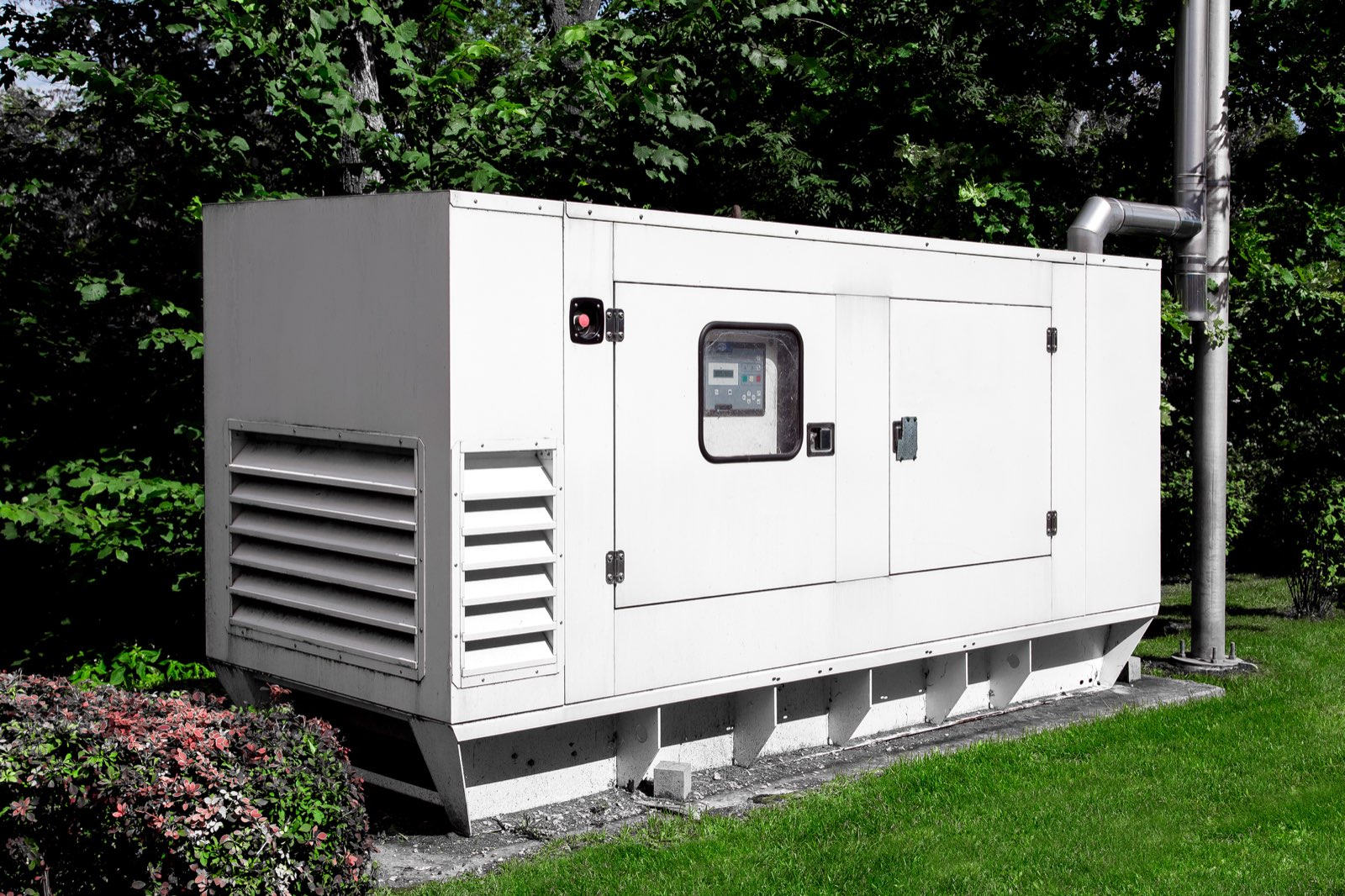 A commercial standby generator outside a secured facility
