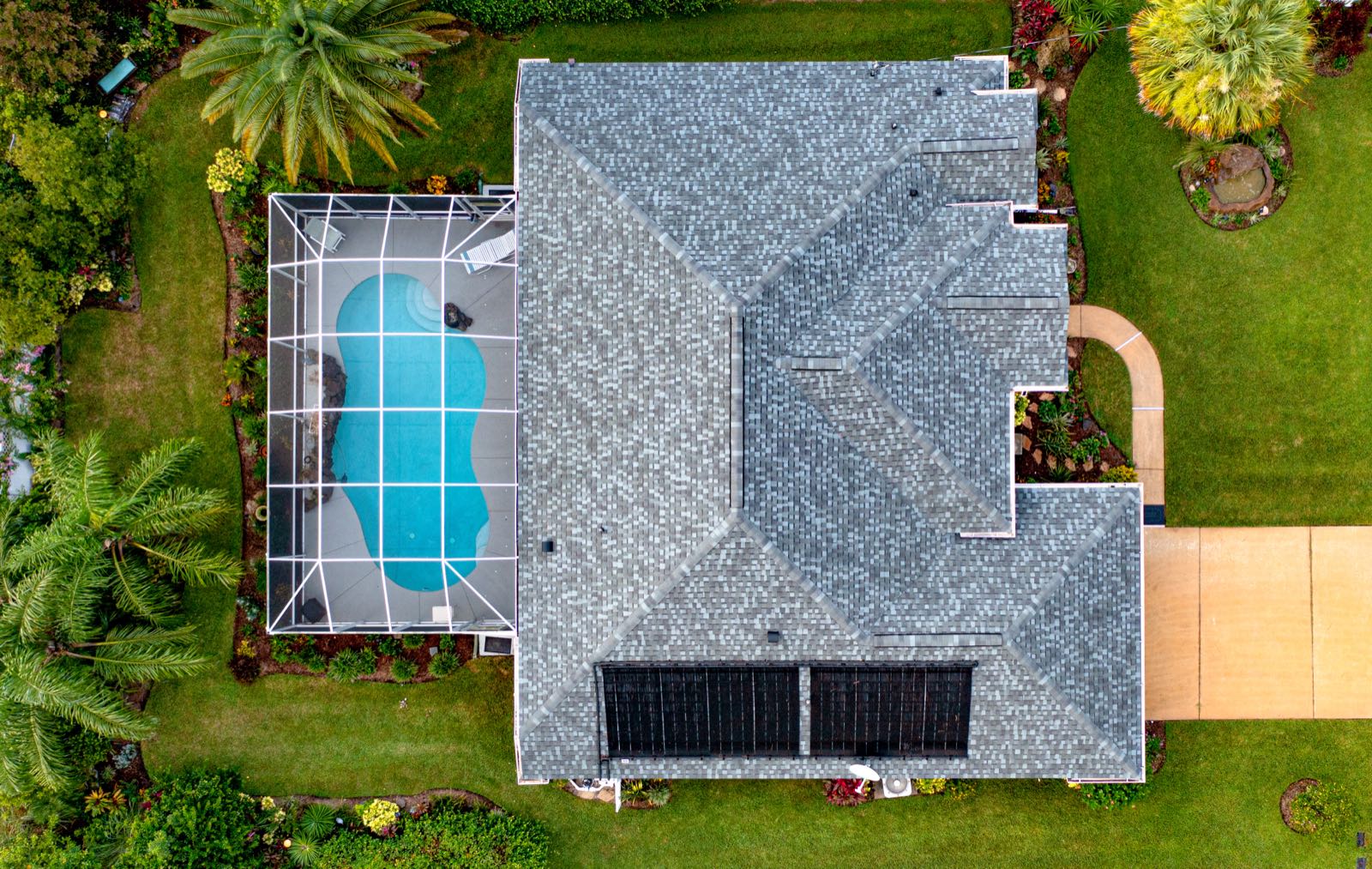 An aerial view of a Florida home with a screened pool